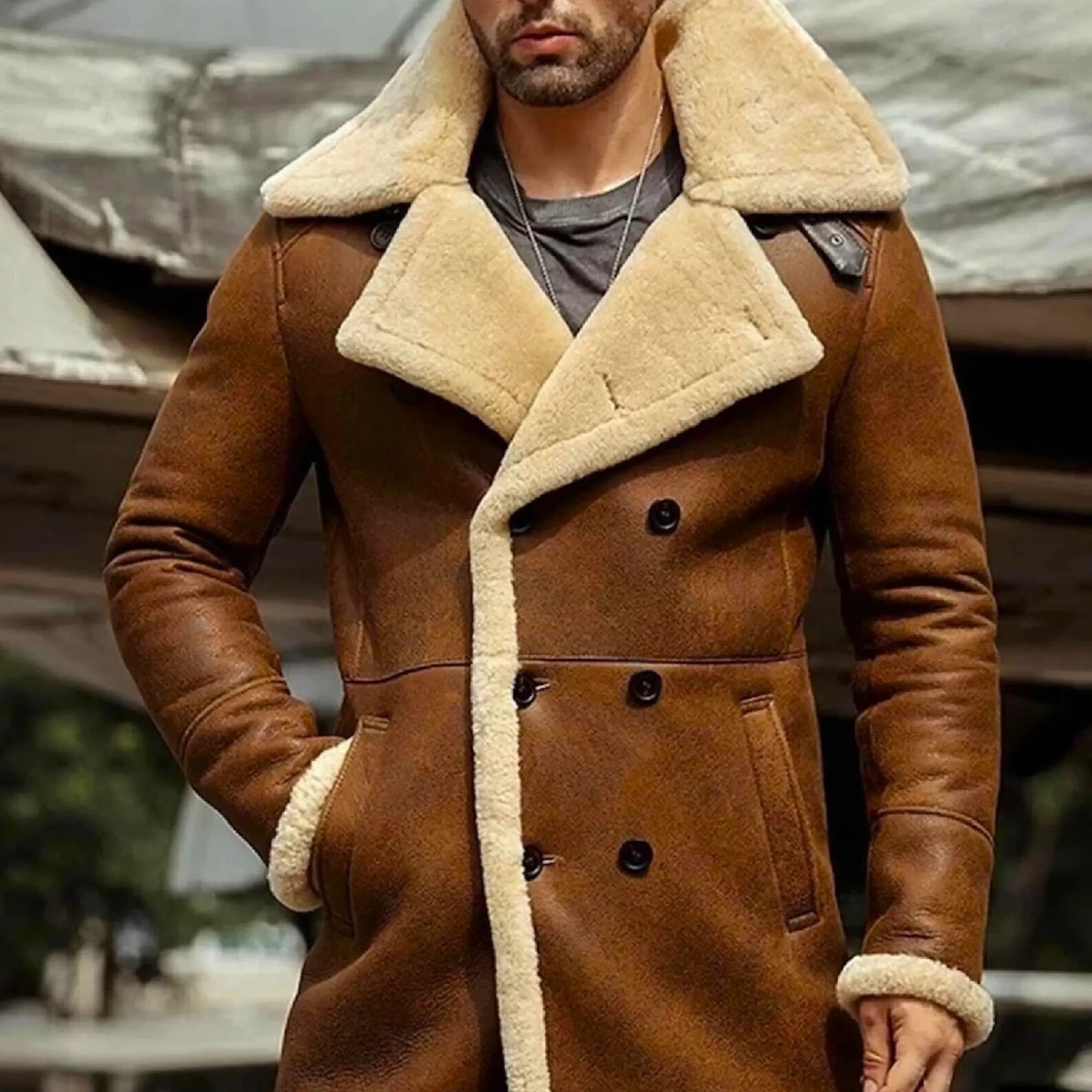 Men's long sheepskin trench coat in brown with cream shearling lining, featuring double-breasted buttons and wide lapels for winter fashion.