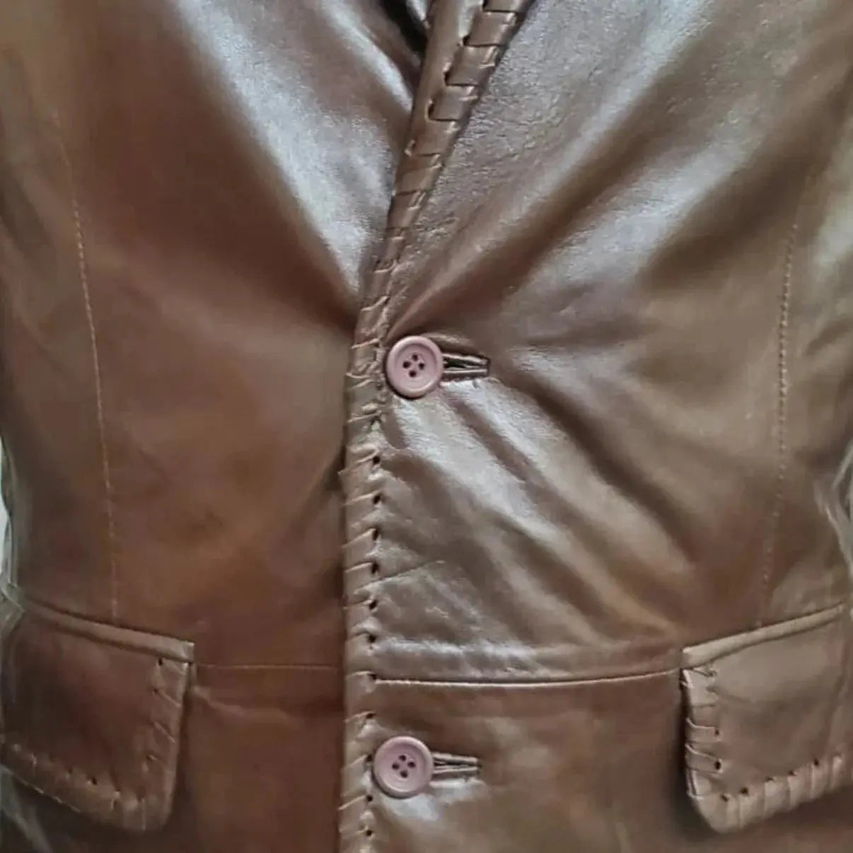 My Store Real Leather Quilted Coat brown leather button front close up with braided trim and flap pockets