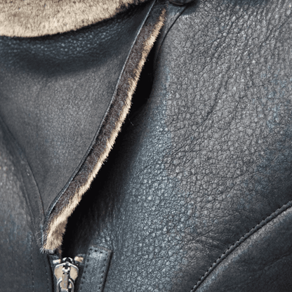 Close up black Sheepskin Shearling Coat with soft beige shearling trim and front zipper detail